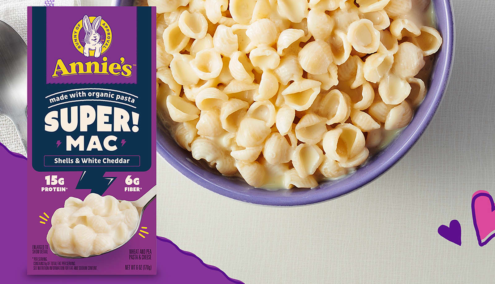 Box of Annie's Super! Mac next to a bowl of macaroni and cheese